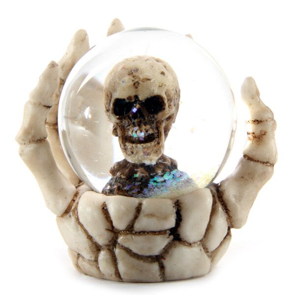 Schedel sneeuwbol in skelet hand